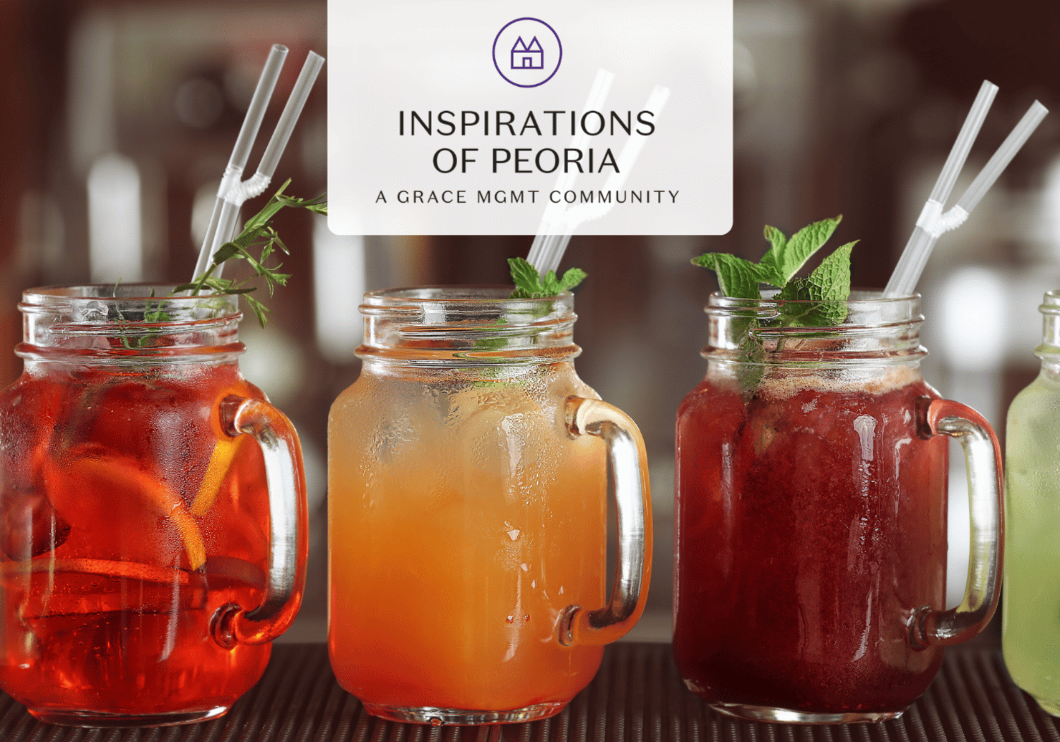 Three mason jar drinks with straws and mint garnish on a bar, a white card reading 'Inspirations of Peoria' centered above them.